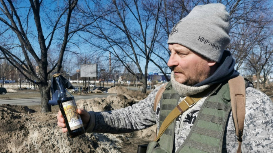 Trenches and Molotov cocktails: Kyiv digs in for war