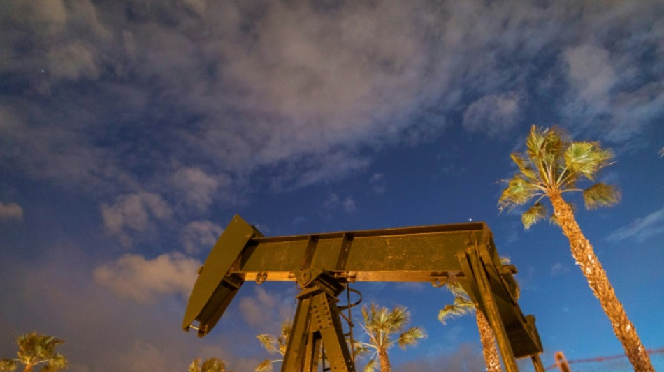 US oil prices slide below $70 a barrel; mixed day for global stocks