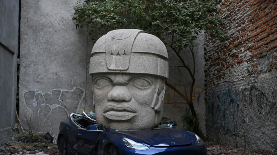 Mexican artist crushes Tesla under giant stone head